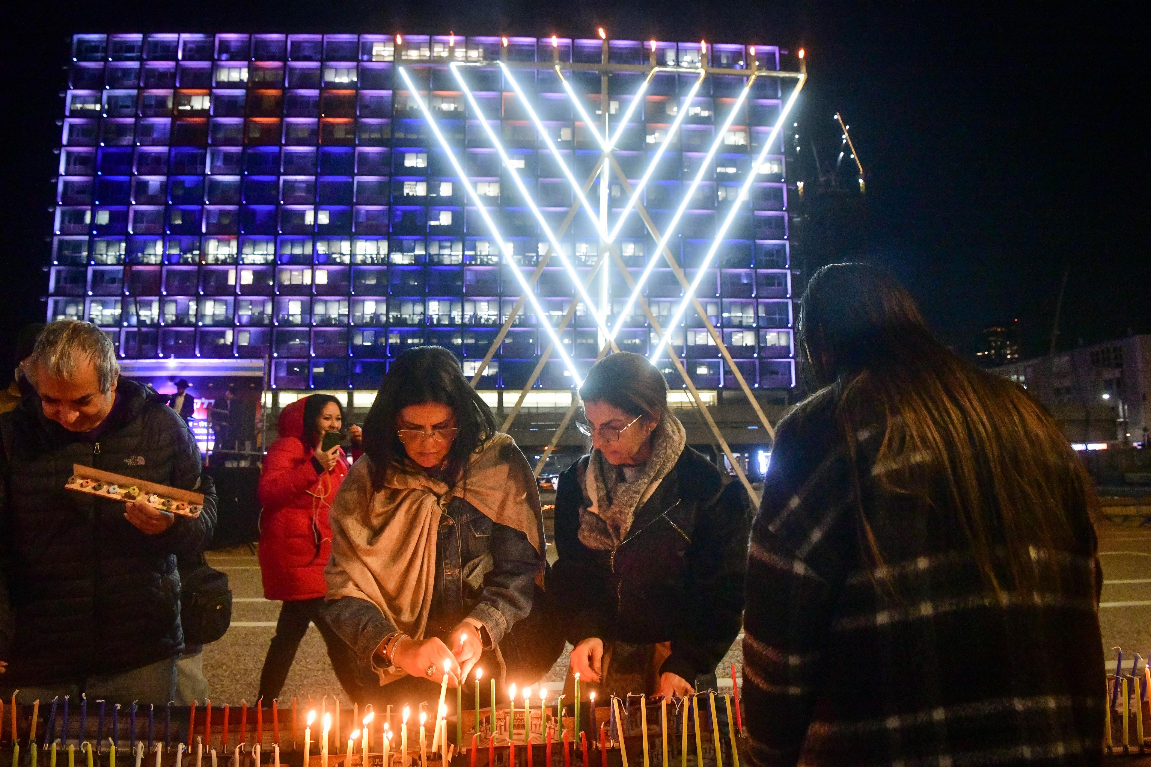 Lighting candles during Hanukkah