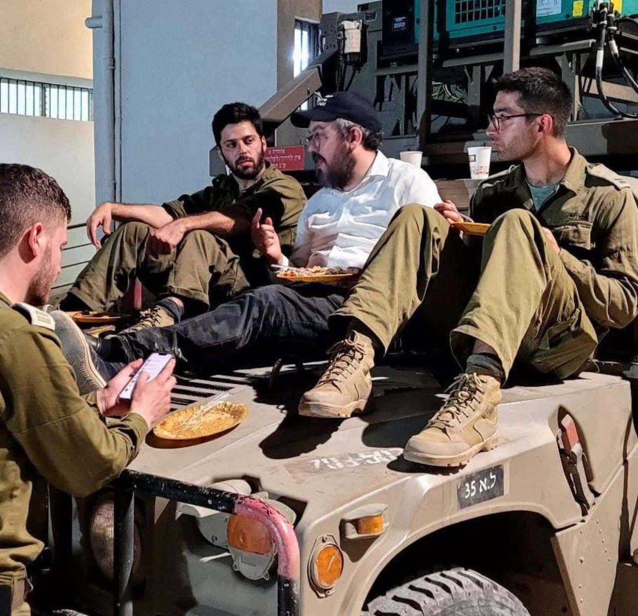 Rabbi Schlanger's Facebook profile photo, with IDF soldiers during a visit to Israel.