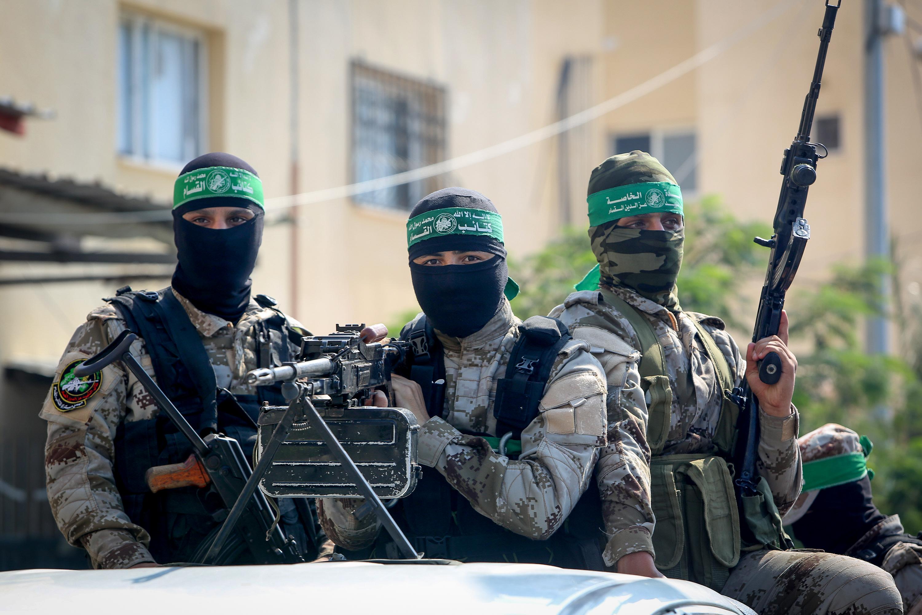 Palestinian fighters from Izz ad-Din al-Qassam Brigades attend a reception for a Palestinian prisoner "Abdel Halim Badawi" after serving 18 years in Israeli prison, in Rafah in the southern Gaza Strip, on October 17, 2019.