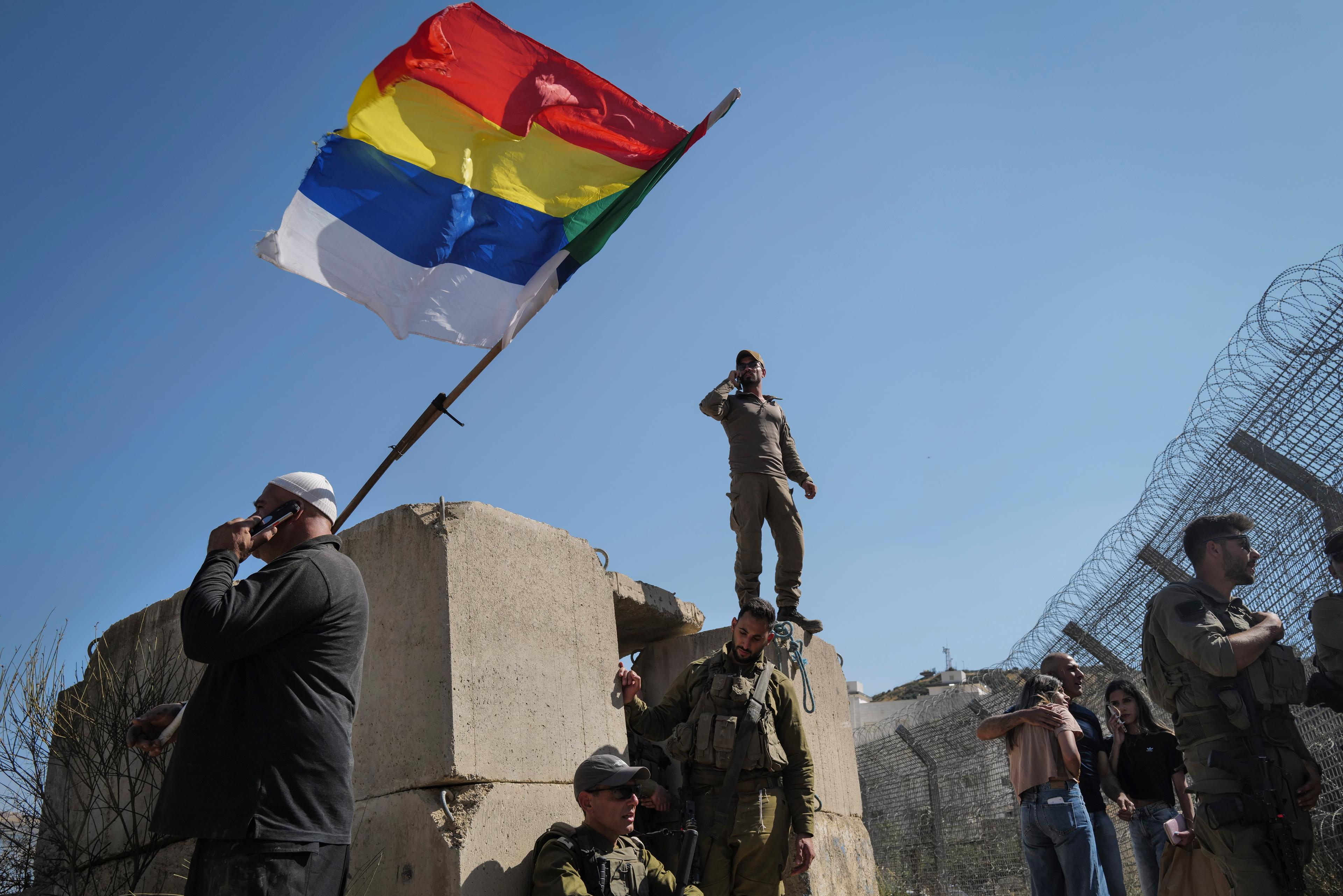 Druze residents protest near the Israeli-Syrian border fence in solidarity with their community in Syria, July 16, 2025.