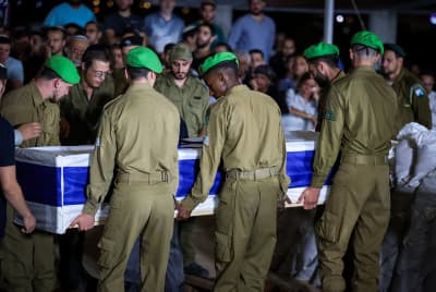 Friends and family attend the funeral of Israeli soldier Staff sergeant Tzur Avraham at the military cemetery in Modi'in June 16, 2024. 